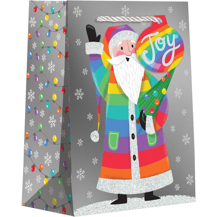 Gift bag with a colorful Santa Claus on a gray background with Christmas lights and snowflakes, and a light gray rope handle. Striped gift tag with "Joy."