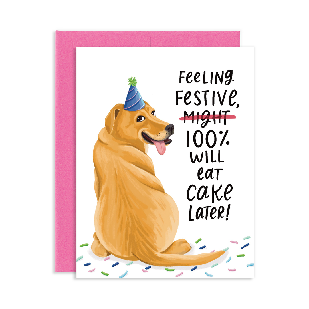 Front of card with a golden retriever sitting on confetti and looking over its shoulder, wearing a blue party hat next to the text 'Feeling festive, might (crossed out), 100% will eat cake later!