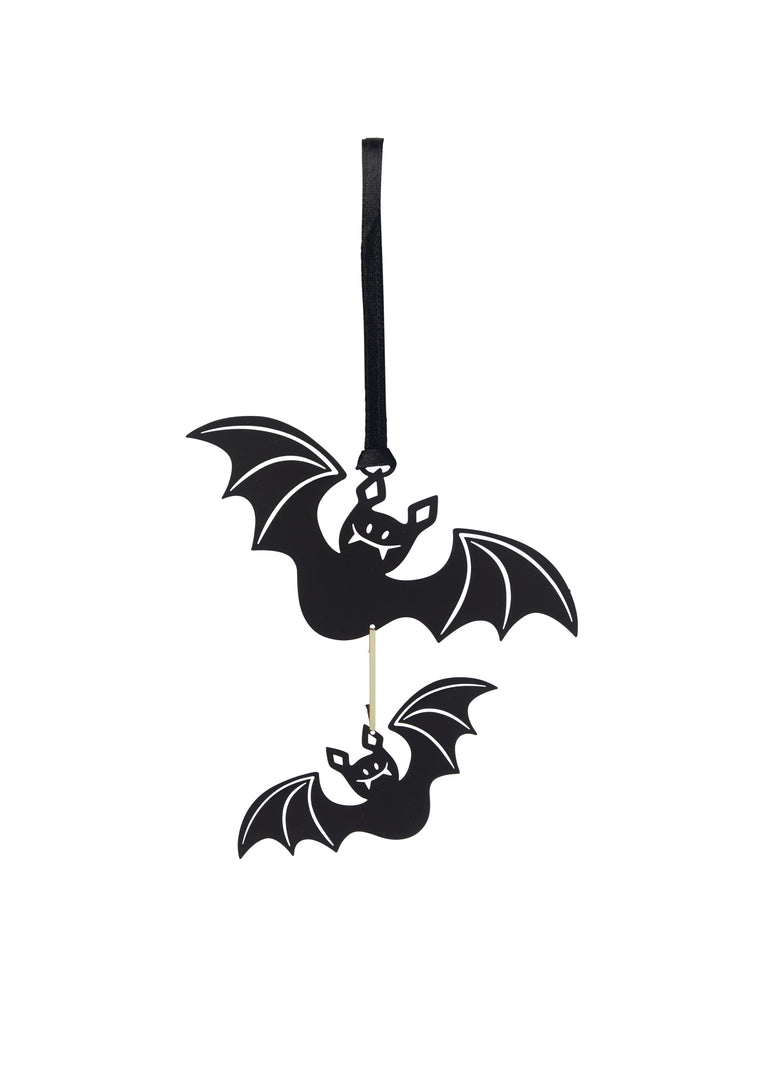 A pair of black metal cutouts of bats, suspended by a black ribbon for hanging.