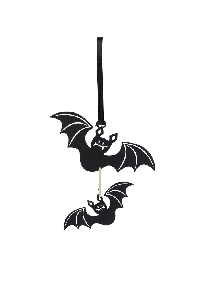 A pair of black metal cutouts of bats, suspended by a black ribbon for hanging.
