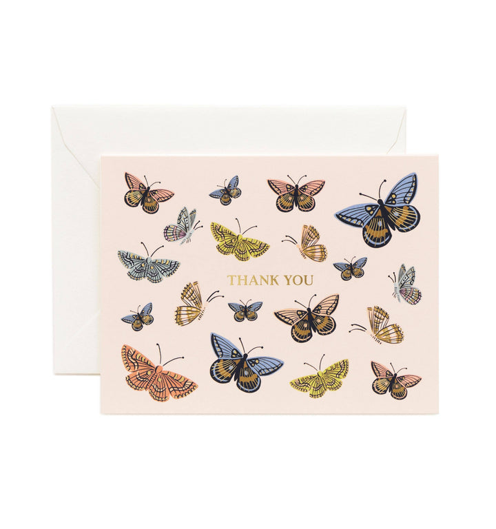 Different colors of monarch butterflies surround the words "thank you."