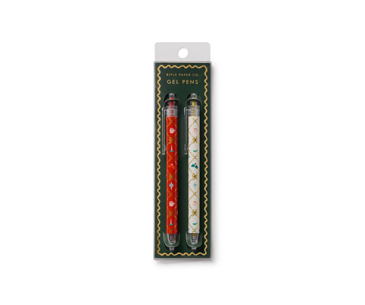 Two pens in packaging, the red with illustrations on the left, and the white with different illustrations on the right.