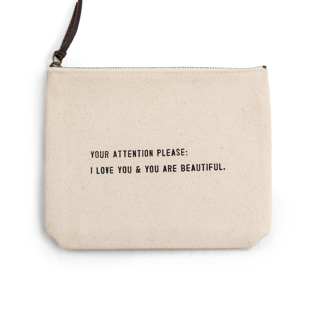 Off-white pouch with a black zipper pull and motivational text in black.