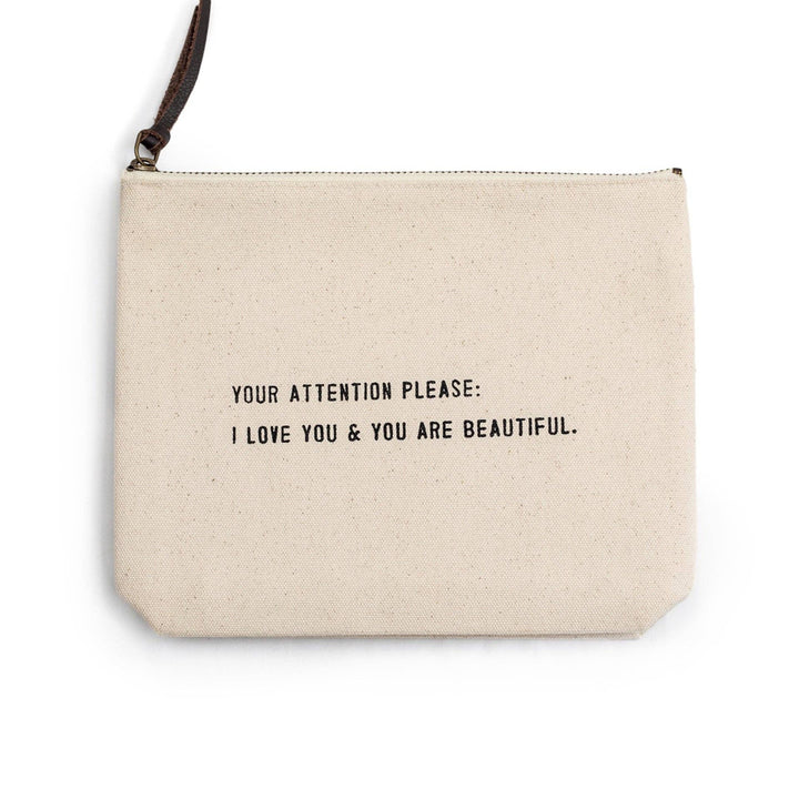 Off-white pouch with a black zipper pull and motivational text in black.