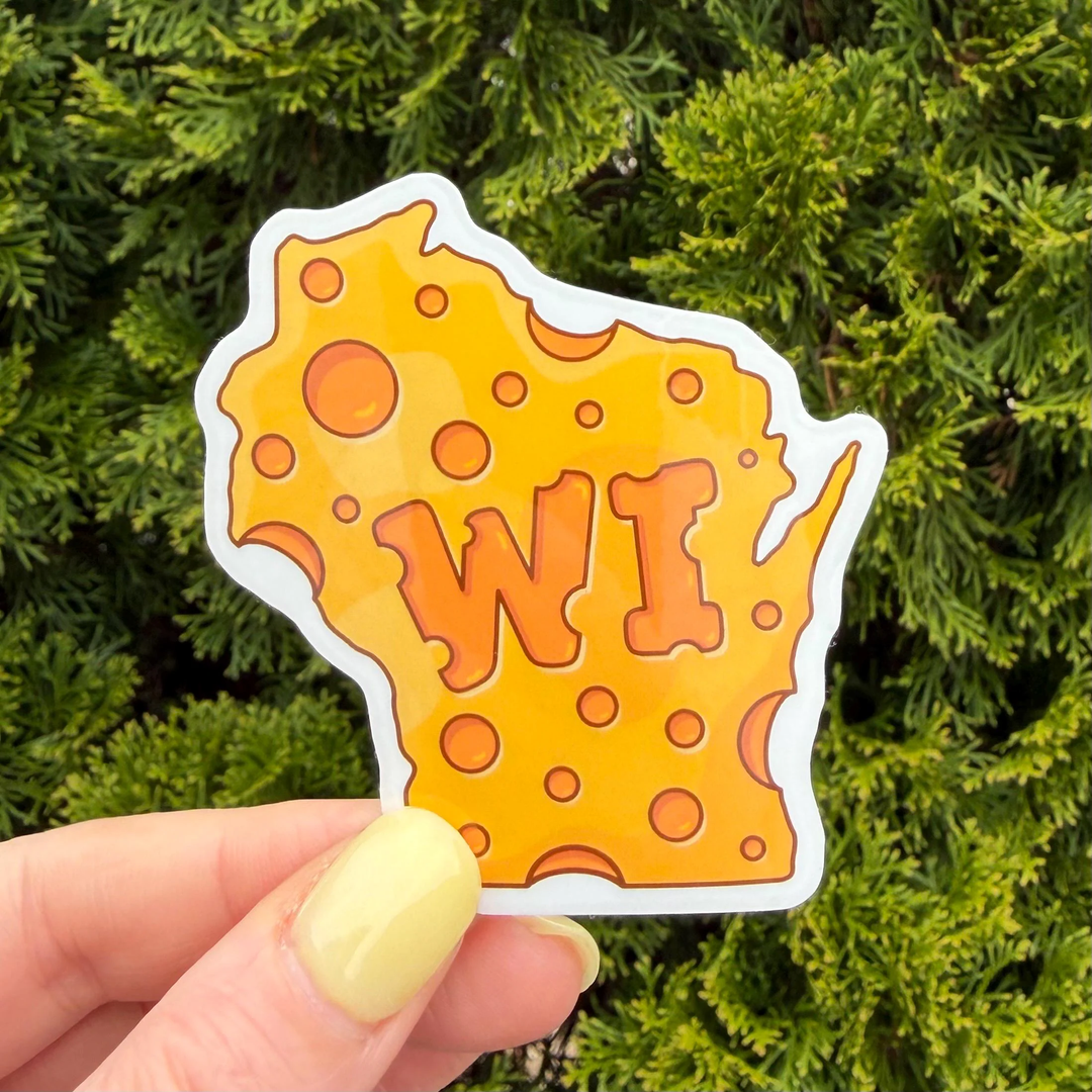 A die-cut sticker shaped like the state of Wisconsin, styled as a slice of cheese with orange holes and the letters 'WI' in the center.