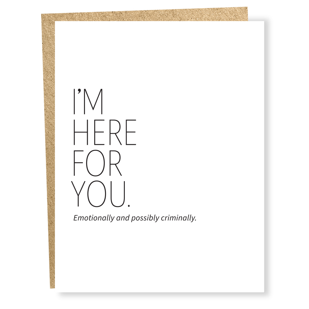 White greeting card with black text in front of a brown envelope