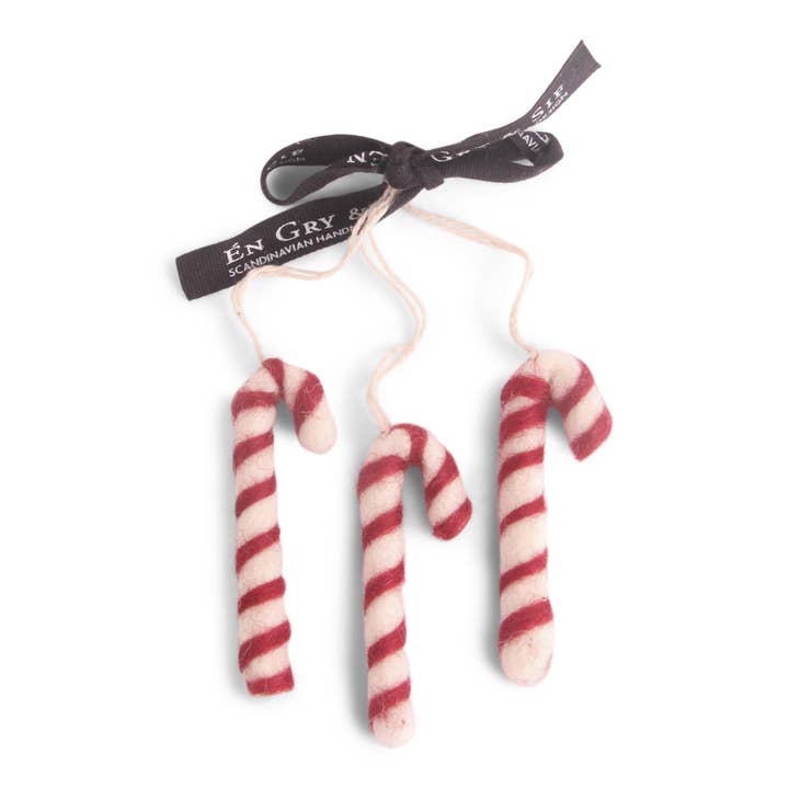 Three felt red and white striped candy canes.