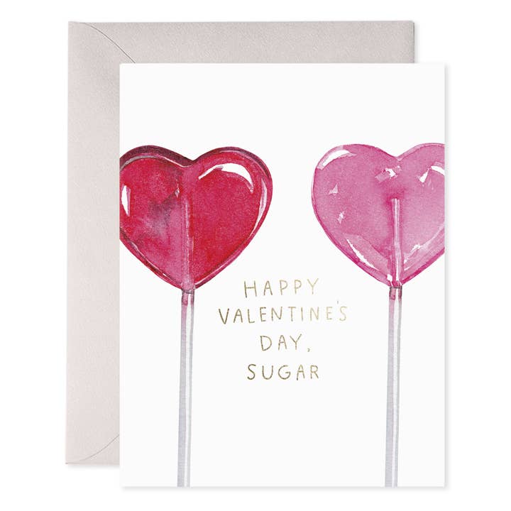 Front of card with two heart-shaped lollipops, one red and one pink on either side of the text "Happy Valentine's Day, Sugar."