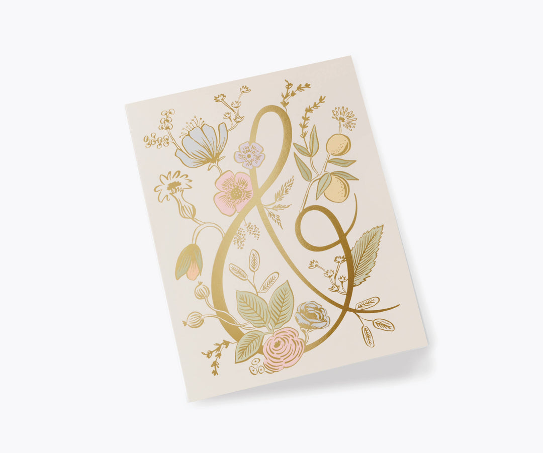 Greeting card with floral decorations and large gold ampersand