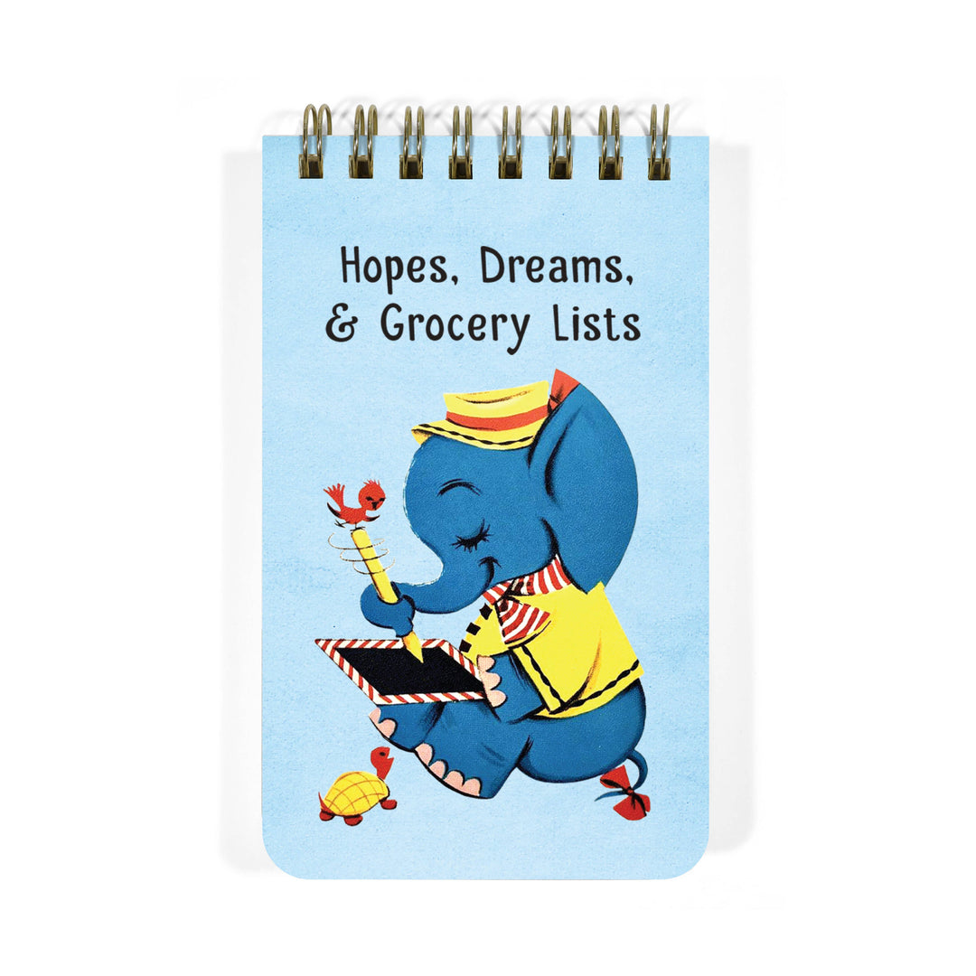 Notepad with a cartoon elephant with text that says 'Hopes, Dreams, & Grocery Lists' on a light blue background.