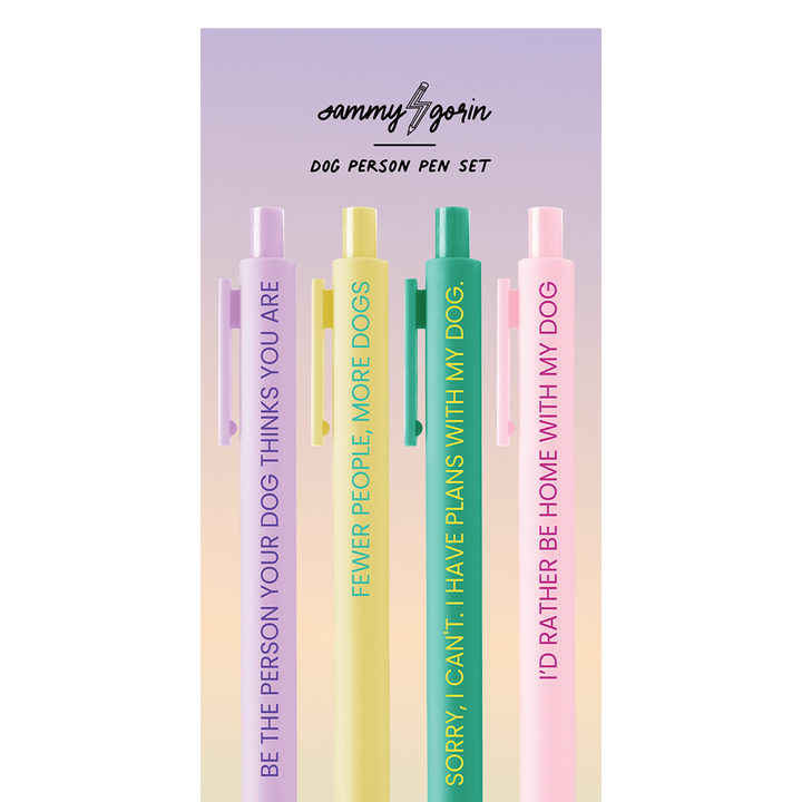 The four pens on a ombre cardboard backing. The color of the pens are: purple text on lilac; green text on yellow, yellow text on green, red text on pink.