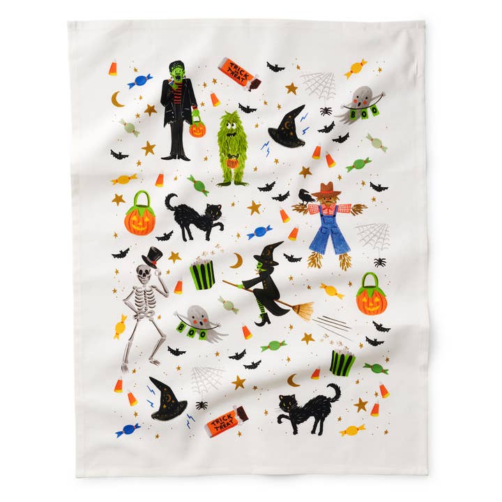 Towel fully open showing all the Halloween objects, including witch's hat, black cat, skeleton, pumpkin, scarecrow.