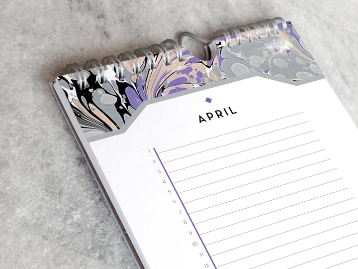 Page for April with marbled paper in shades of gray and lavender at the top and bottom. Below the month title is a line for each day of the month.