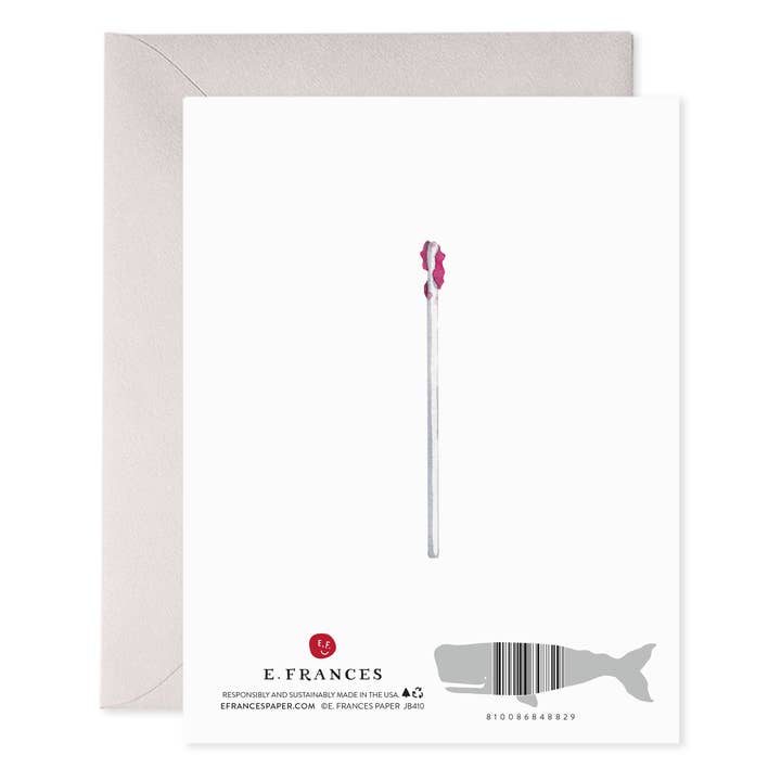 Back of card with a few pieces of the lollipop left on a white stick.