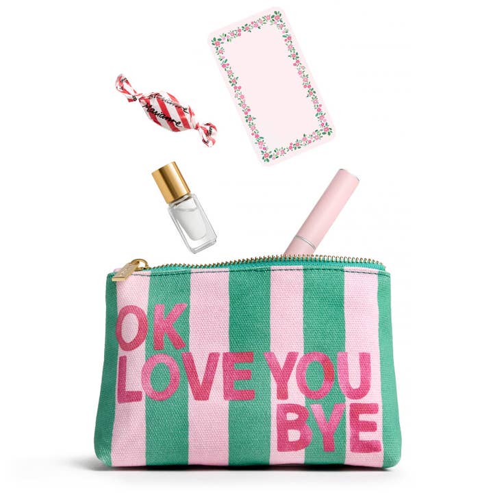 Open pouch with small items - a piece of candy, a notepad, and makeup - falling into it.