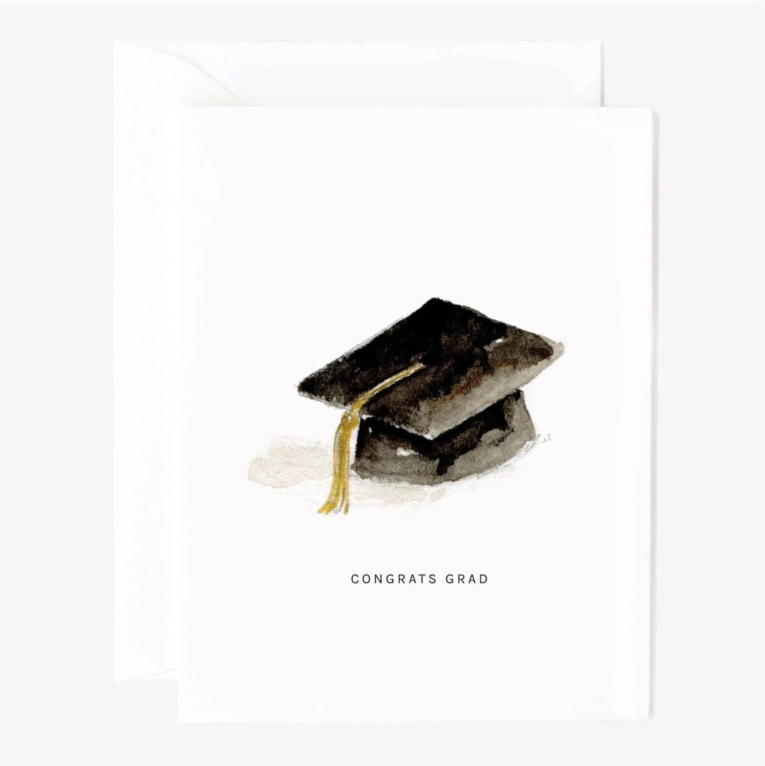Watercolor of a mortarboard with gold tassel over the text 'Congrats grad' on a white background with white envelope.