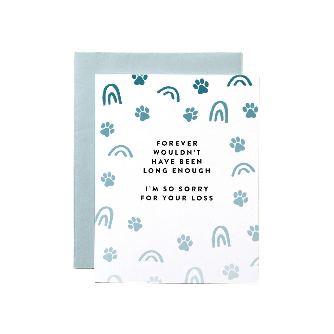 Pet paw prints and rainbows, both in light teal, dot the card front, with black text in the center.