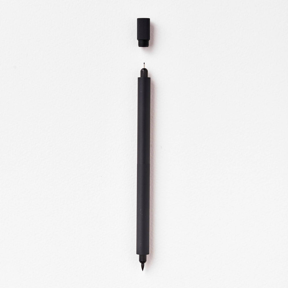Duo pen with cap suspended above the fineline tip.
