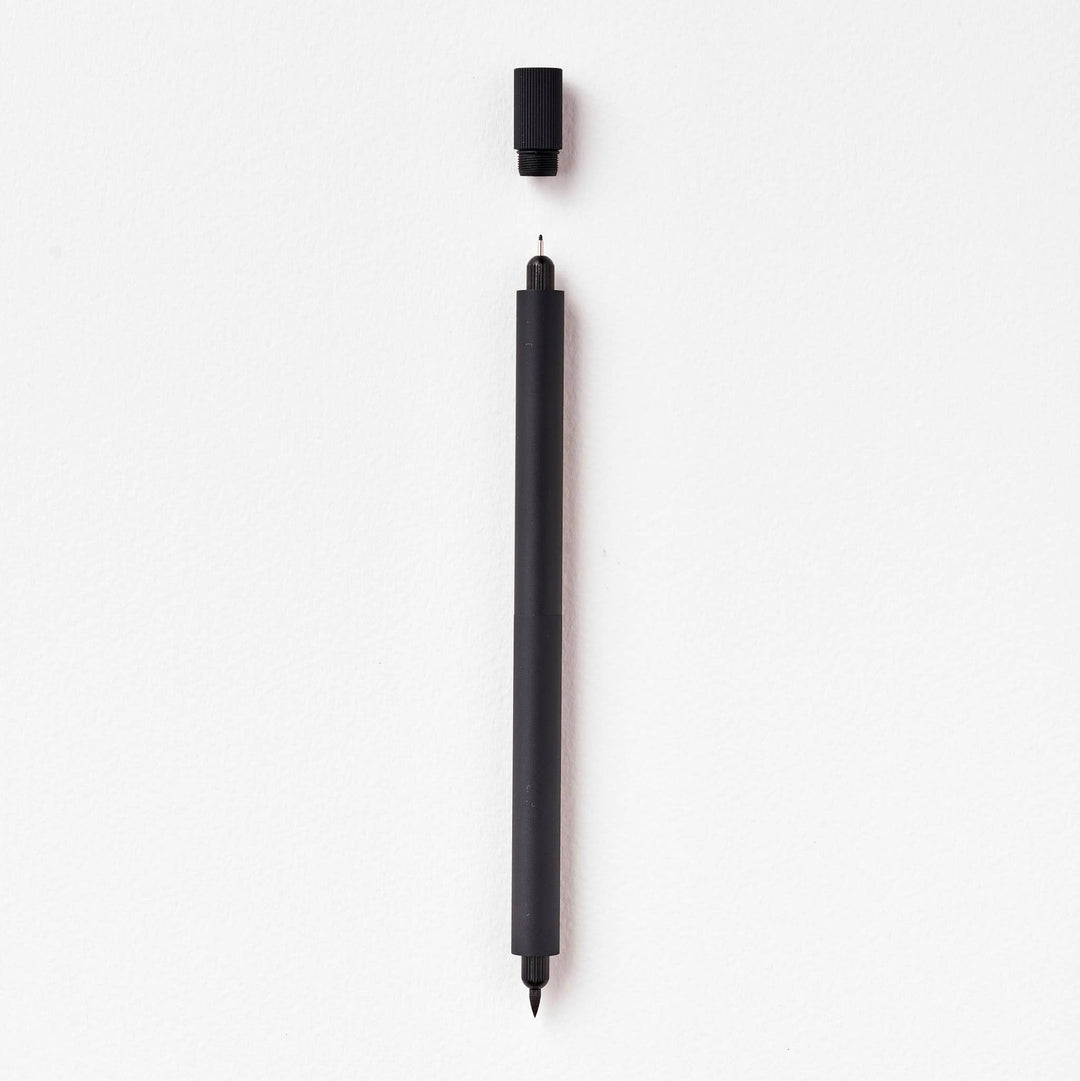 Duo pen with cap suspended above the fineline tip.