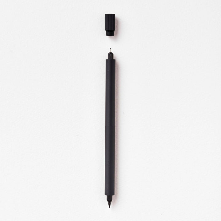 Duo pen with cap suspended above the fineline tip.