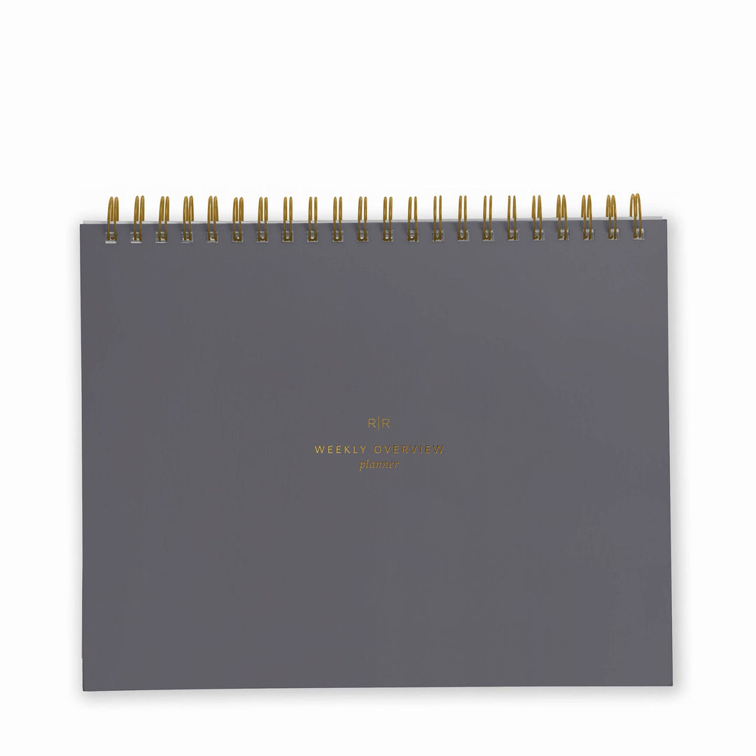 Cover of weekly planner in charcoal with gold spiral binding at top.