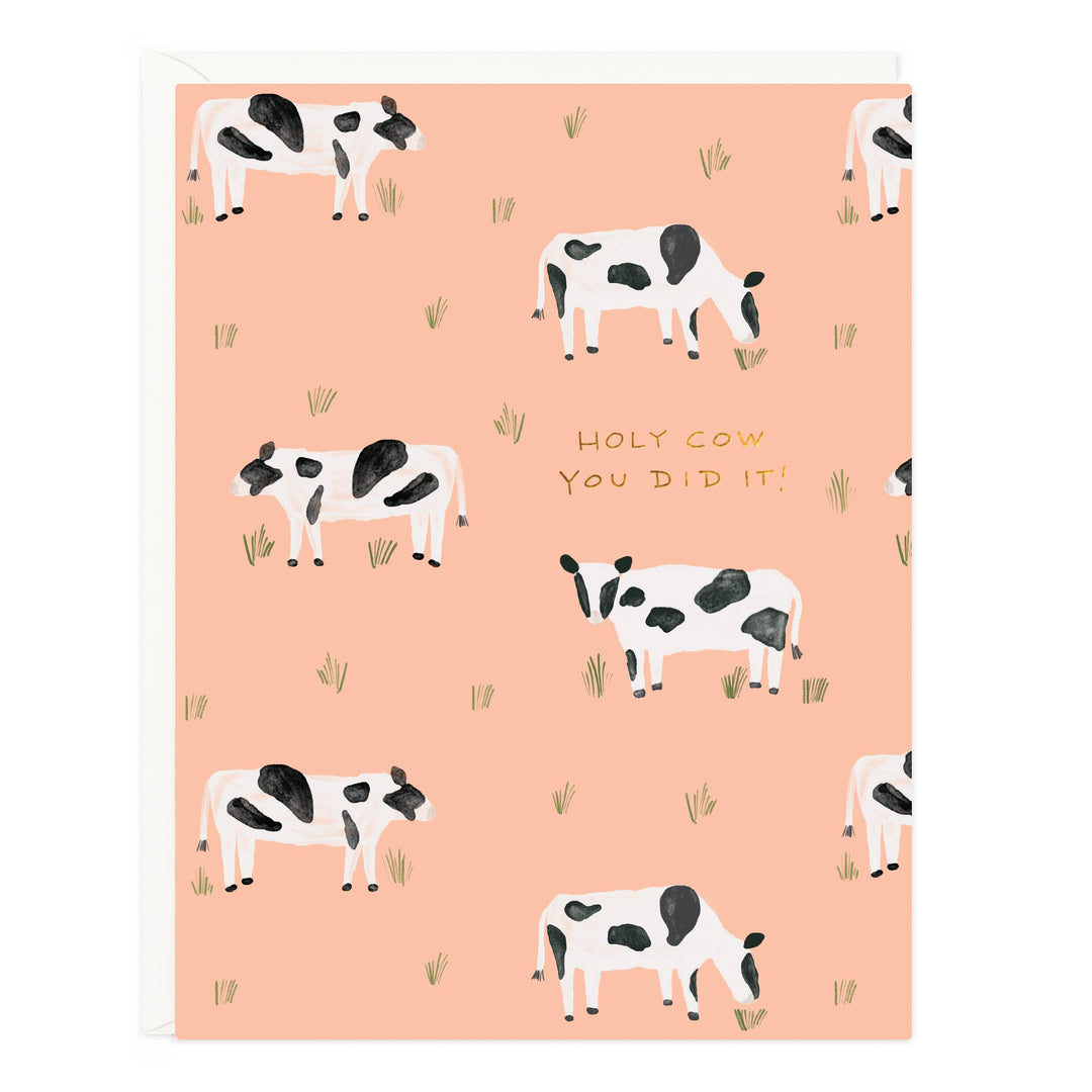 Front of car with pattern of black and white cows eating grass and the text 'Holy Cow. You Did It!' on a pinkish-beige background.