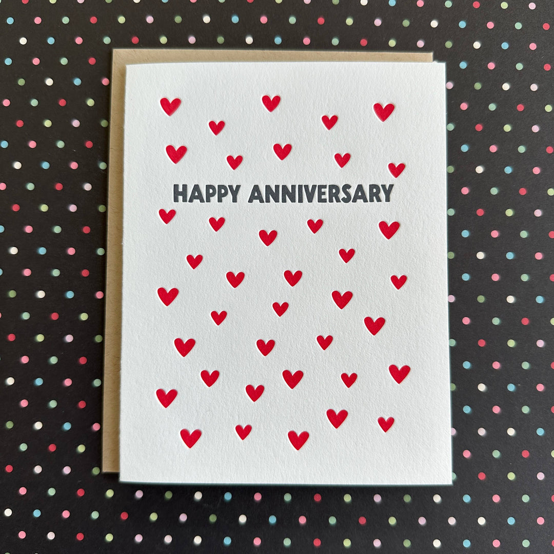 Dozens of red hearts sprinkled on the card, with dark gray text on white card stock