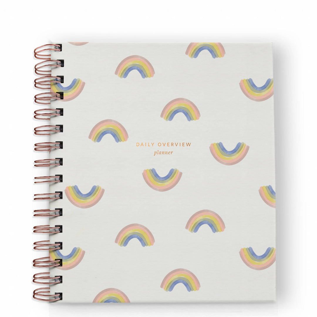 Cover of planner with a pattern of rainbows.