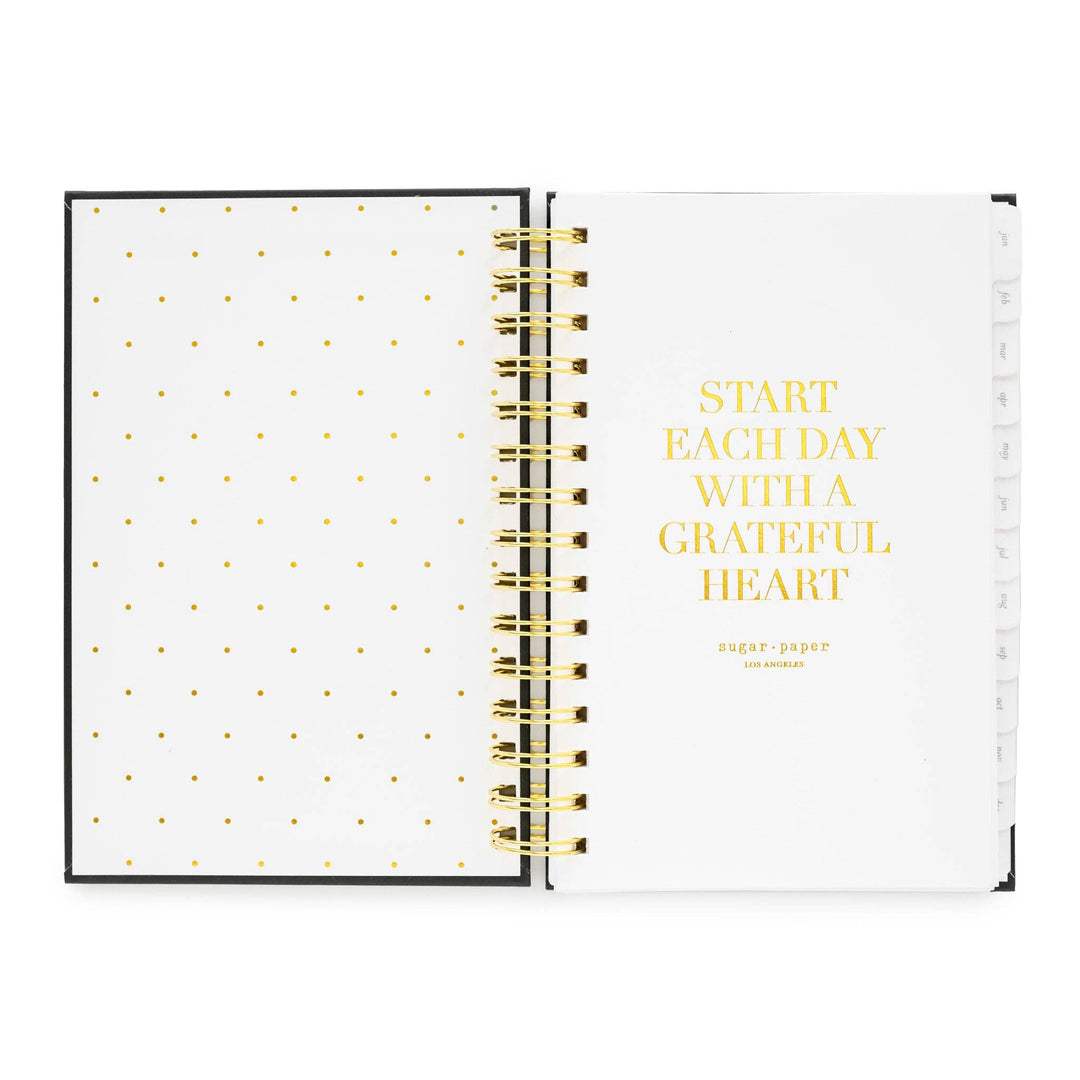 Inside cover of notebook, with dots on the left side and an inspirational quote on the right, 'Start each day with a grateful hear.'