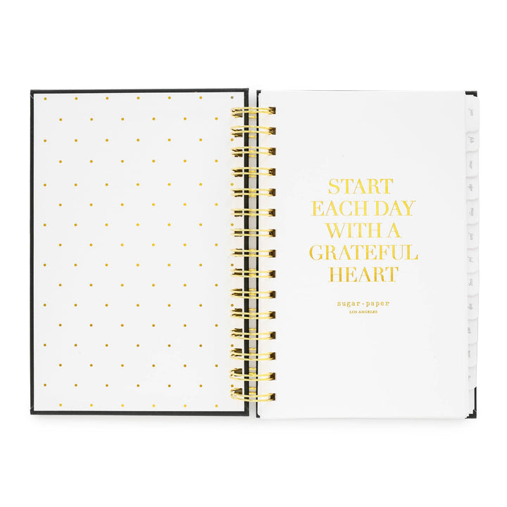 Inside cover of notebook, with dots on the left side and an inspirational quote on the right, 'Start each day with a grateful hear.'
