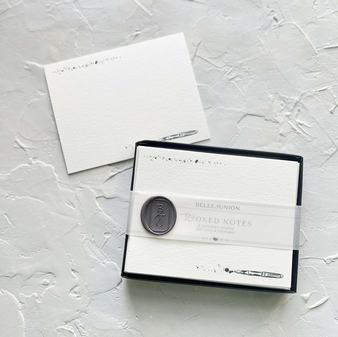 Off-white notes with illustration of scribbles a the top and a fountain pen at the bottom, in a box.