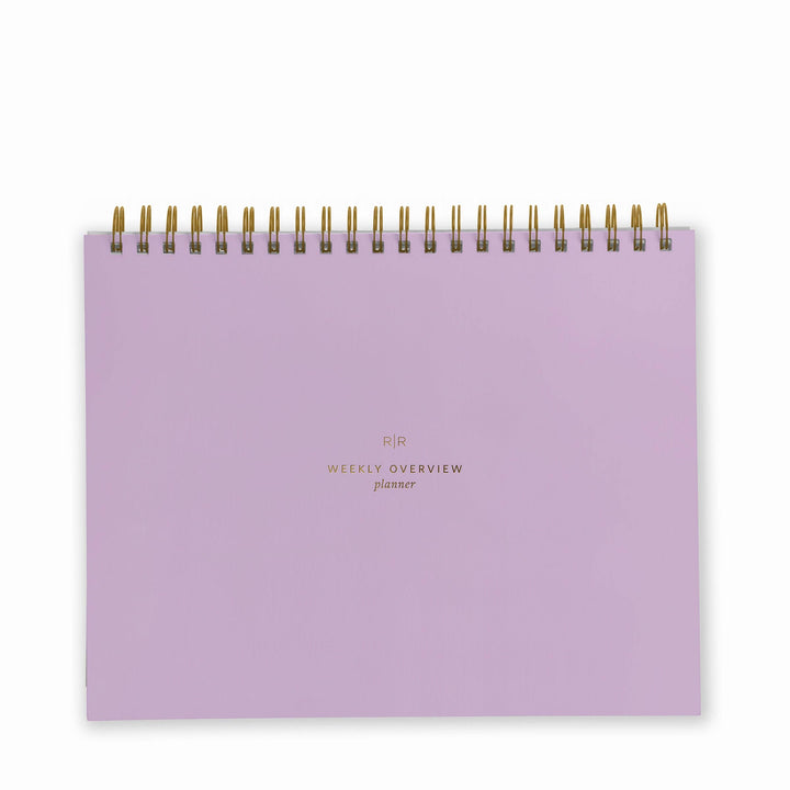 Cover of weekly planner in lavender with gold spiral binding at top.
