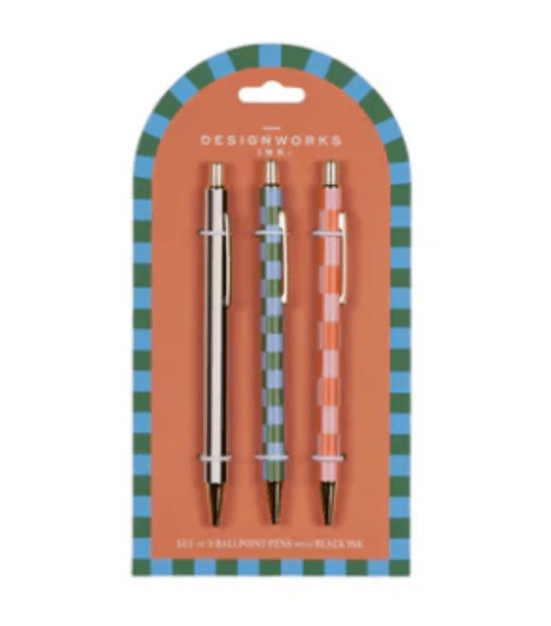 Three pens - one gold, on blue and green horizontal stripes, and one with orange and pink horizontal stripes - on an orange card with blue and green border.