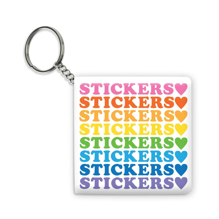 Small square sticker book with the text 'Stickers" in rainbow lettering on a keychain.