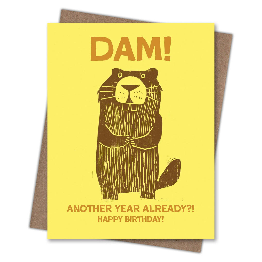 Birthday card with beaver illustration and the text "DAM! ANOTHER YEAR ALREADY?! HAPPY BIRTHDAY!" on a yellow background