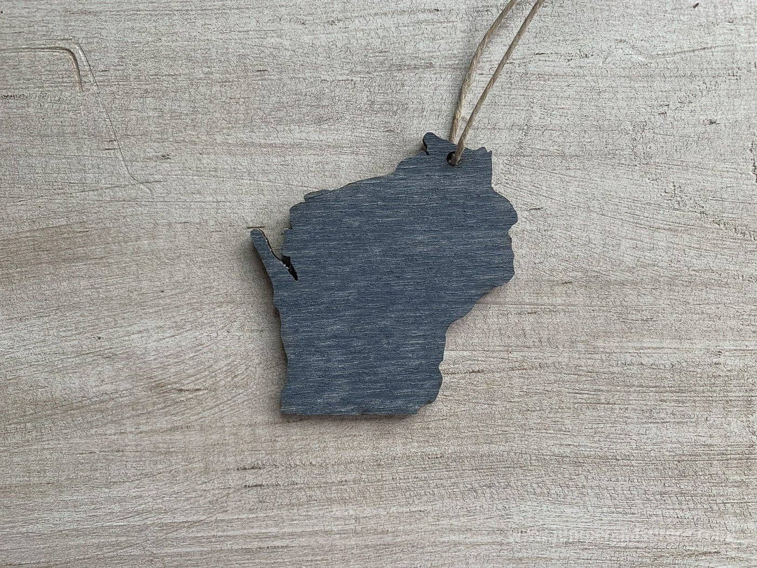 Gray back side of wooden ornament shaped like the state of Wisconsin.