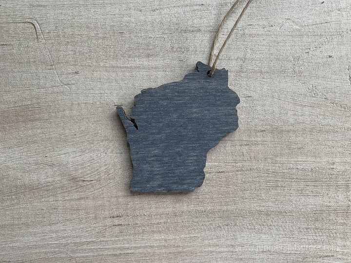 Gray back side of wooden ornament shaped like the state of Wisconsin.