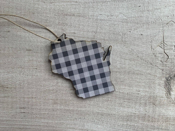 Ornament cut in the shape of the state of Wisconsin in black buffalo plaid and a hanging string.