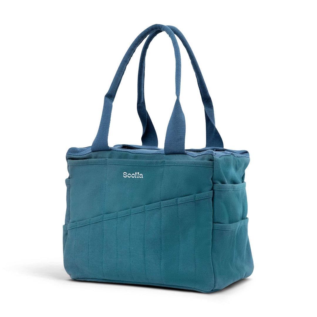 Aquamarine studio bag at an angle, with 10 narrow pockets on the long side and two wider pockets on the end side. 