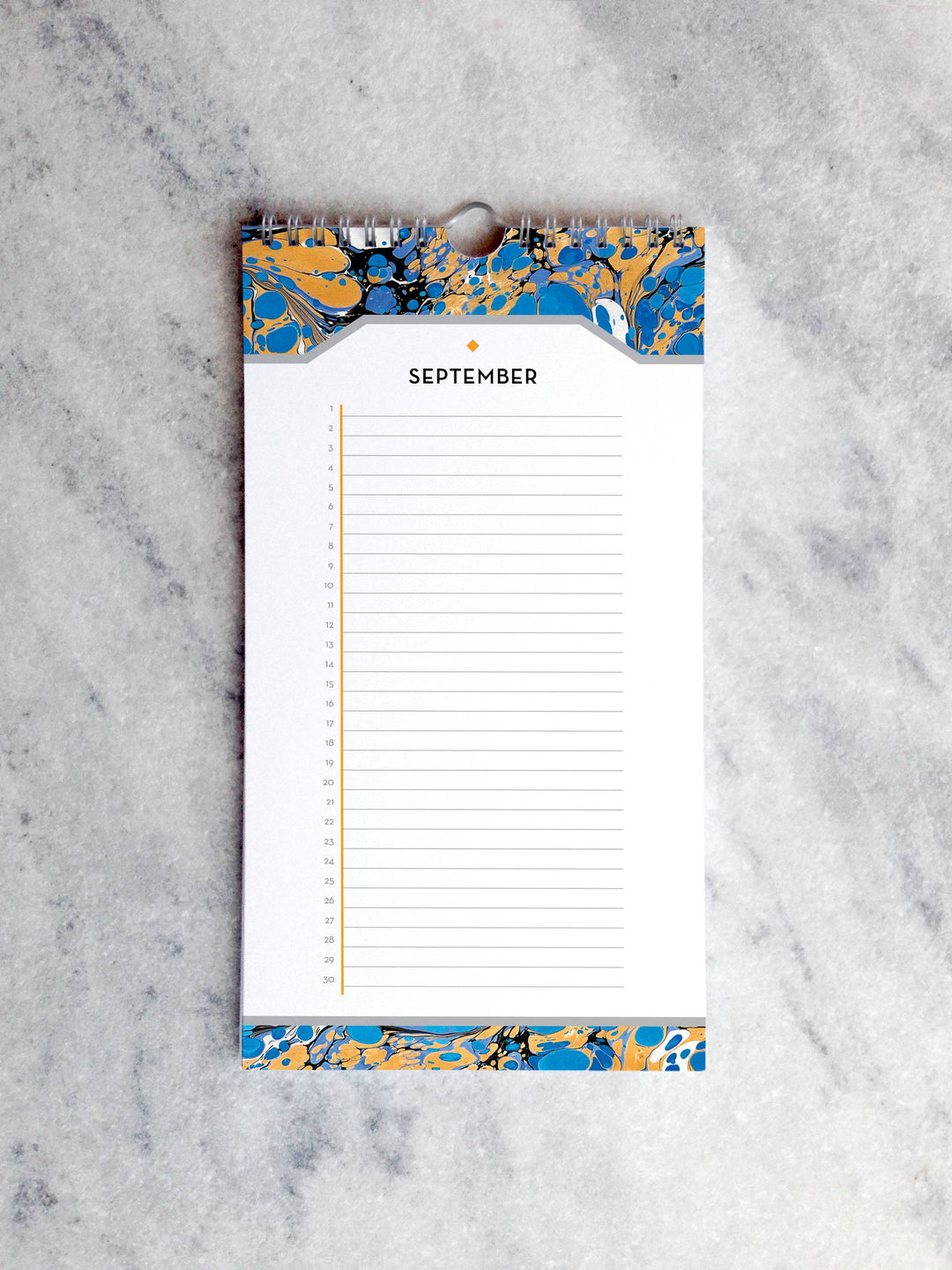 Page for September with marbled paper in shades of blue and orange at the top and bottom. Below the month title is a line for each day of the month.