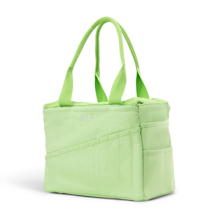 Lime studio bag at an angle, with 10 narrow pockets on the long side and two wider pockets on the end side. 
