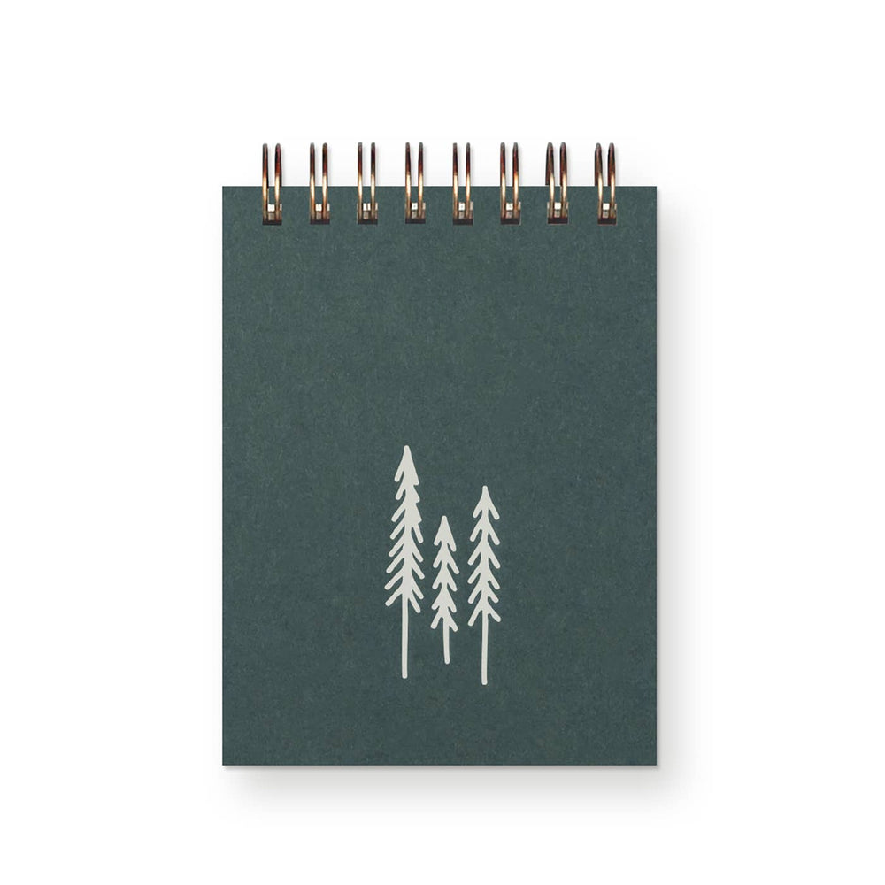 Dark green cover with sturdy wire binding and three evergreen trees in silver.