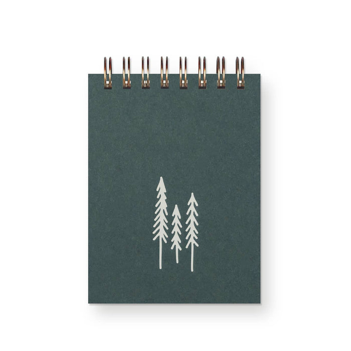 Dark green cover with sturdy wire binding and three evergreen trees in silver.