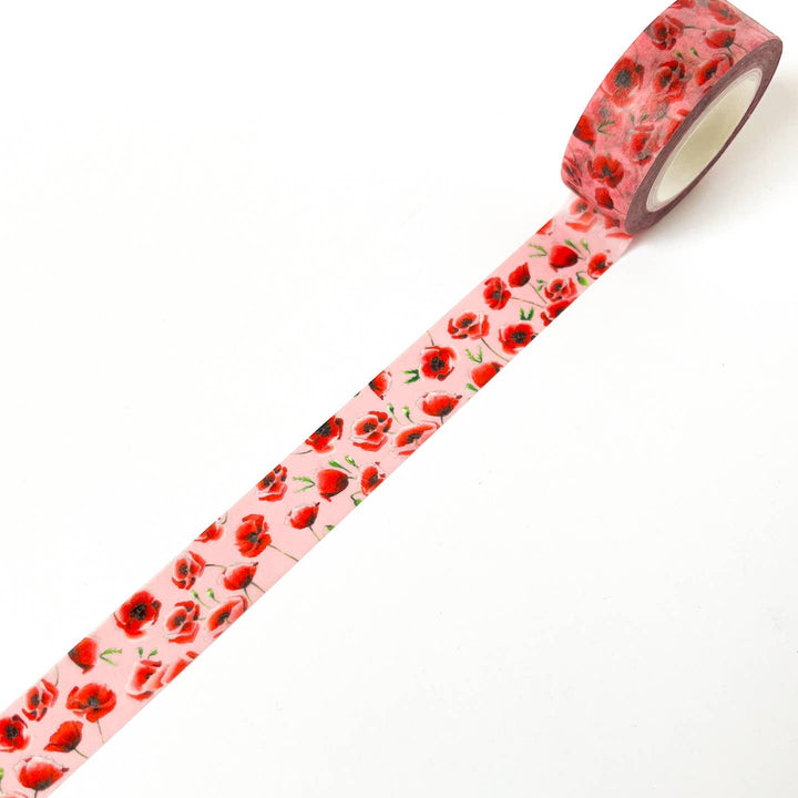 Roll of tape with red floral pattern on a white background