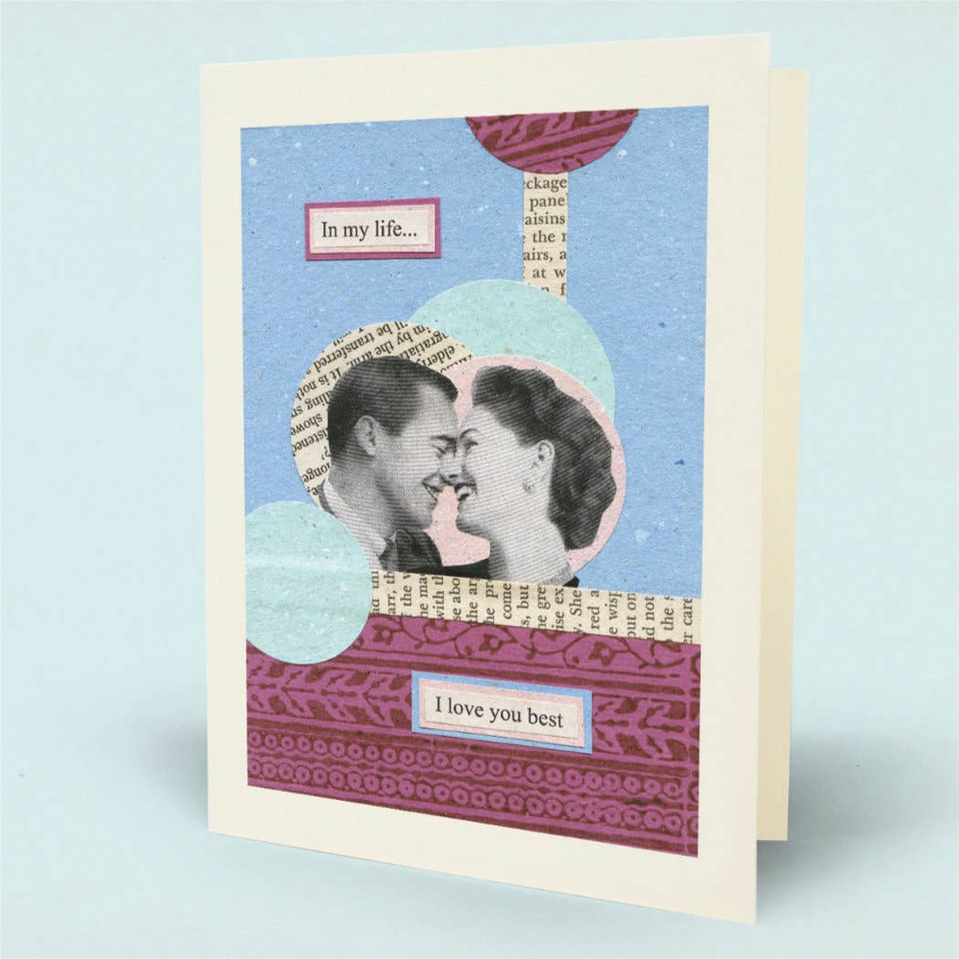 A greeting card with a retro collage design, featuring a couple's portrait, vintage book text, and pink patterned accents on a light blue background.
