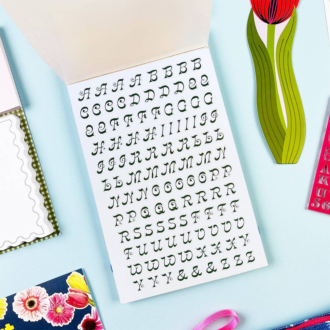 Sheet of cursive capital letter stickers in black.