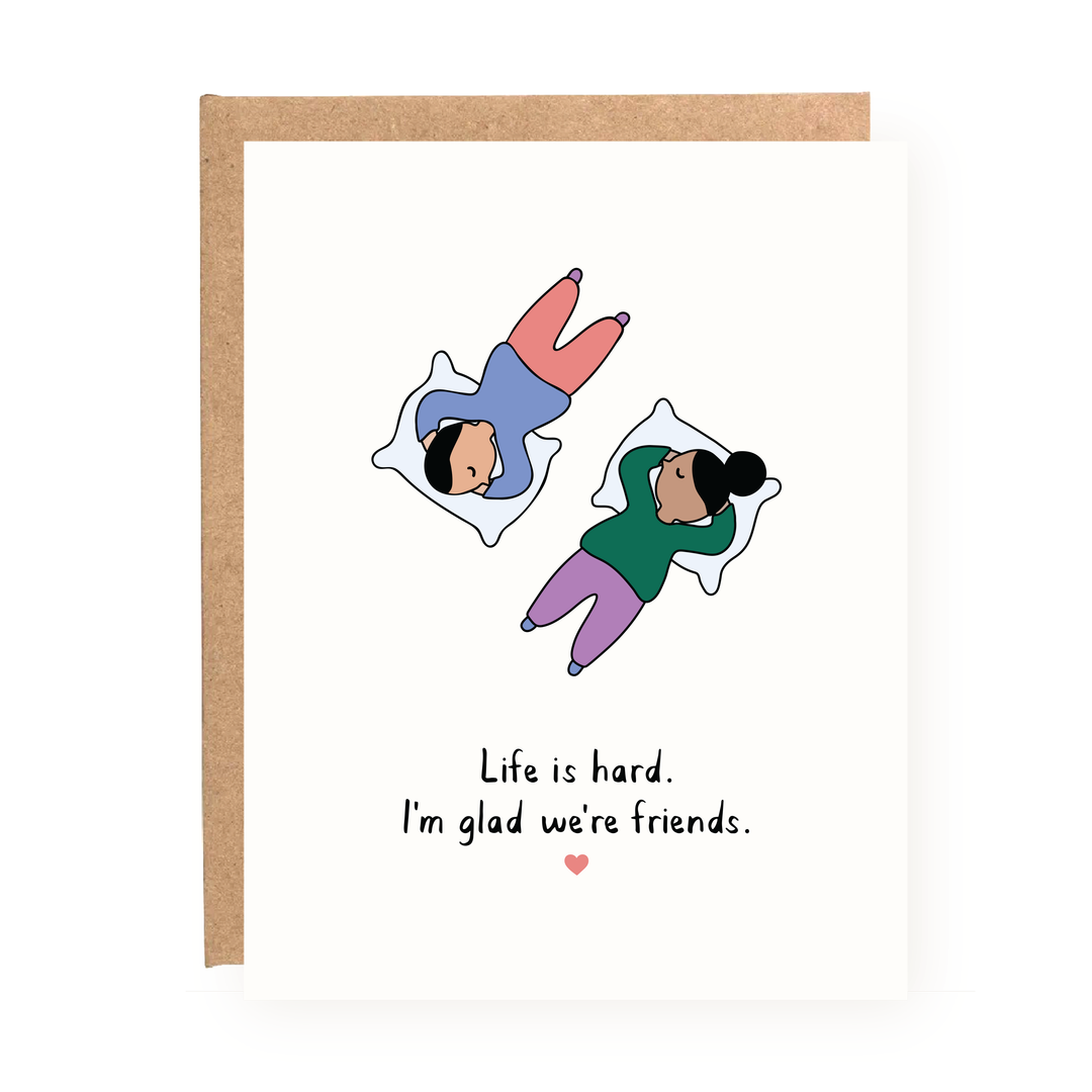 Front of card with two people lying head to feet and text 'Life is hard. I'm glad we're friends.'
