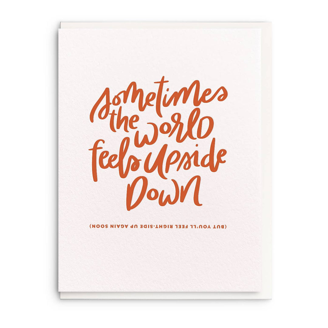 Hand lettered text, in orange on what cardstock. Second sentence is printed upside down.