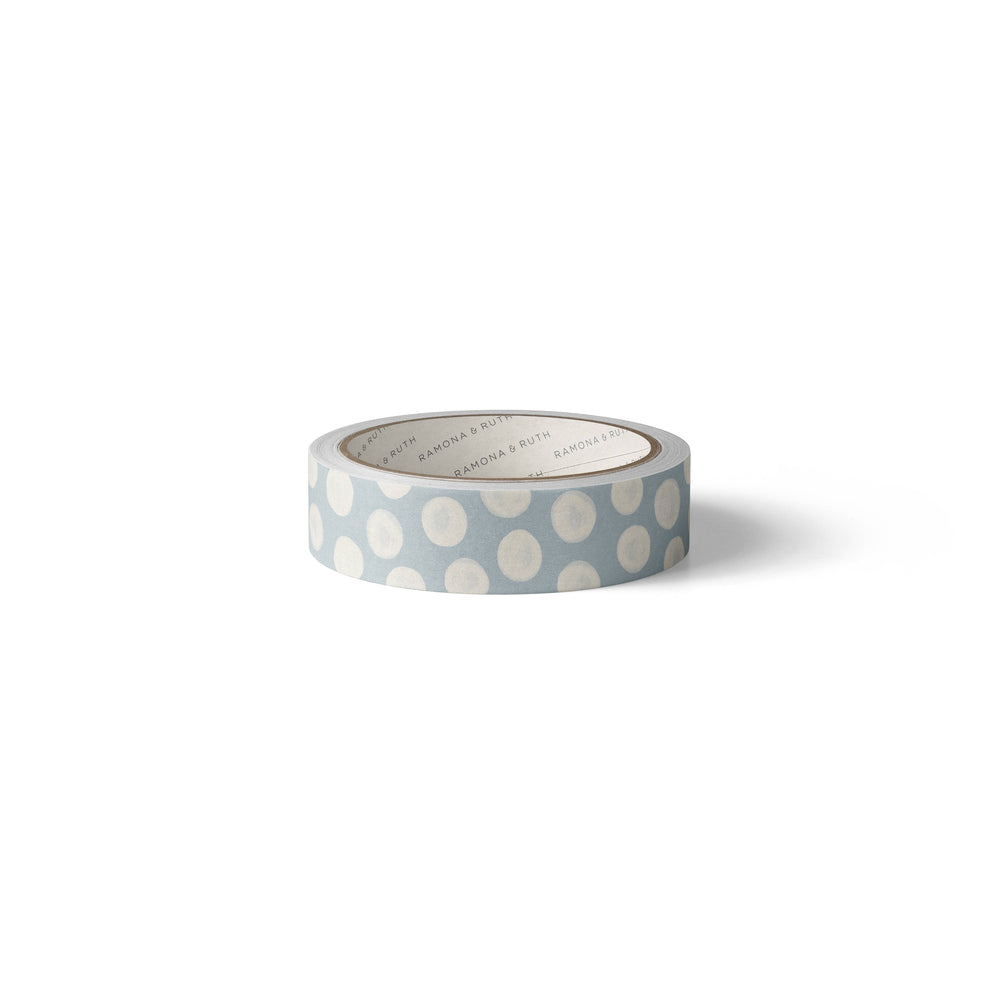 Side view of white dots on a roll of light blue washi tape.