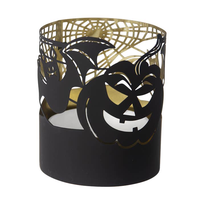 A black metal candle holder with laser-cutout designs of a jack-o'-lantern, bats, and a spider web, and with a gold-colored interior.